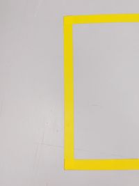 High angle view of yellow sign on wall