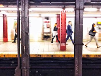 Blurred motion of people at railroad station