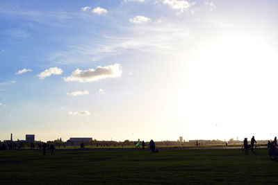 People on landscape against sky