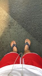 Low section of man standing on zebra crossing