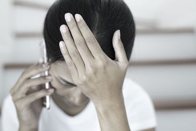Close-up portrait of a man covering face