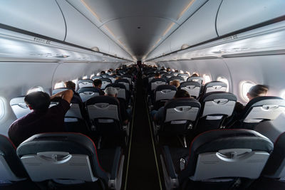 Rear view of people sitting in airplane