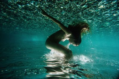 Young woman swimming in sea
