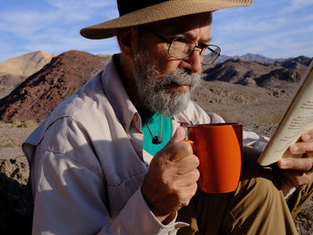 Portrait of young man holding drink