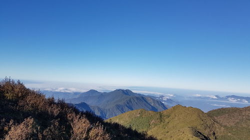 View of mountain range against blue sky