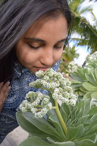 Close-up of woman smelling flowers