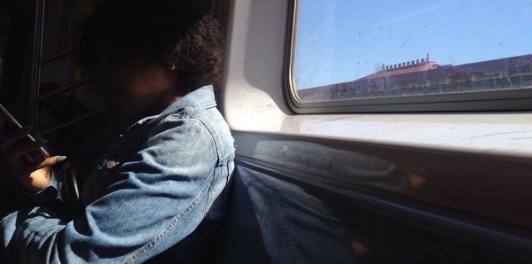 View of man sitting in train