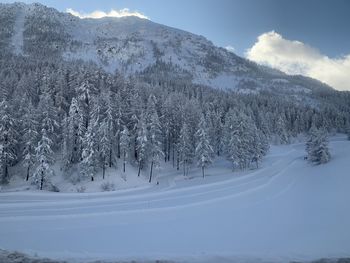 Scenic view of snow covered mountains against sky