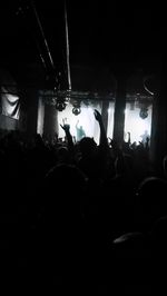 Blurred motion of woman in dark room