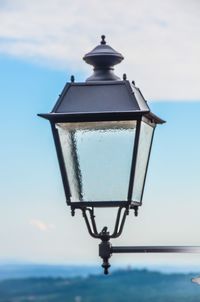 Close-up of lamp post against sky