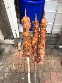 Low angle view of meat hanging on barbecue grill