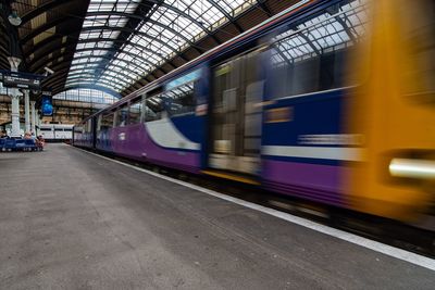 Blurred motion of train at railroad station