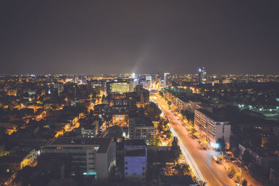 High angle view of illuminated buildings against sky at night