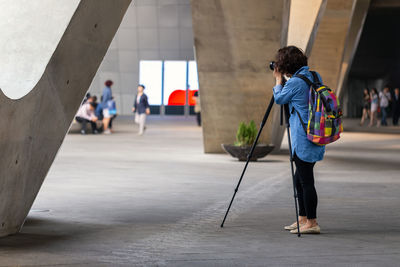 People walking on footpath in city