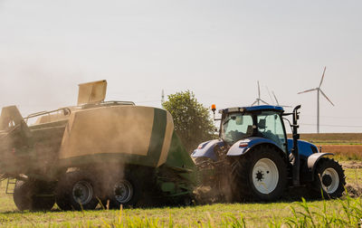 Tractor on field against clear sky