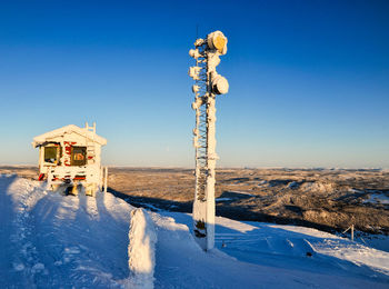 Cabin against clear blue sky