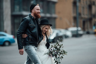 Young couple kissing on street in city