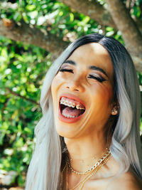 Portrait of young trans woman laughing