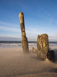 Scenic view of beach against cloudy sky