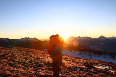 Man standing on mountain during sunset