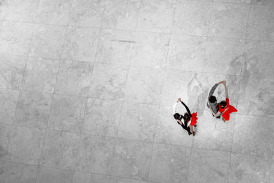 High angle view of couple dancing on tiled floor