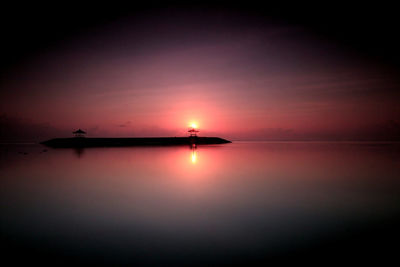 Scenic view of sea against romantic sky at sunset