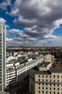 Cityscape against cloudy sky