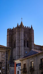 Low angle view of historic building against clear blue sky