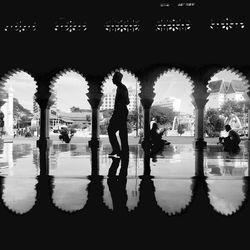 Silhouette people standing by water