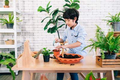 Woman holding food on potted plant