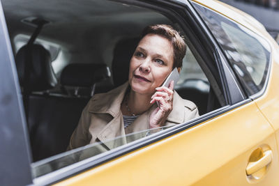 Woman in taxi on cell phone