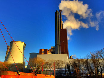 Low angle view of skyscraper against blue sky