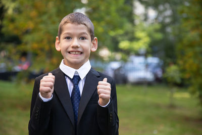 Portrait of smiling boy standing outdoors