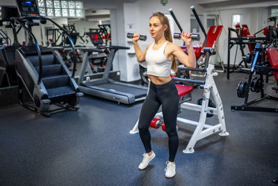 Side view of woman exercising in gym