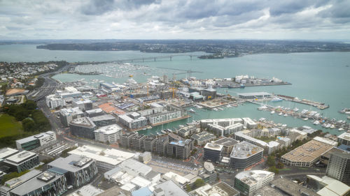 High angle view of buildings by sea against sky