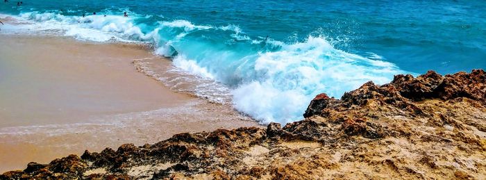 Waves breaking on rocks at shore