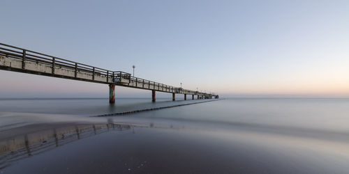 View of bridge over sea against clear sky