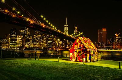 Illuminated built structure against sky at night