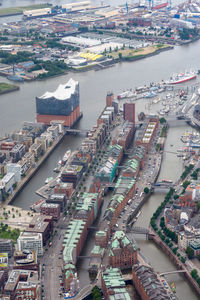 Aerial view of river amidst buildings in city