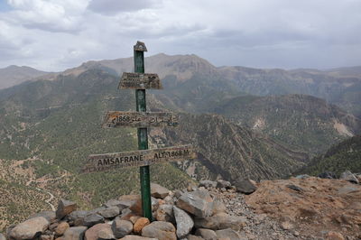 Information sign on rock against sky