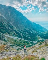 Man standing on mountain against sky
