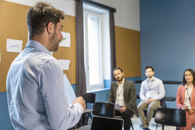 Businessman explaining business strategy to colleagues in office meeting