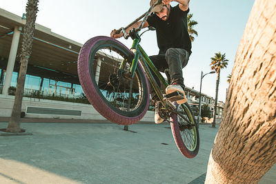 Man cycling on bicycle against sky