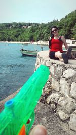 Portrait of woman sitting on shore