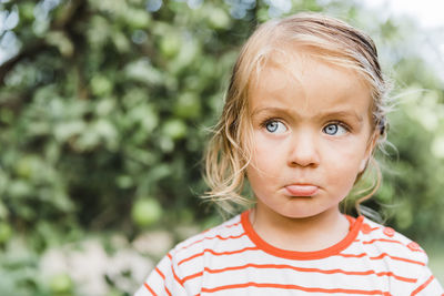 Portrait of cute girl standing outdoors