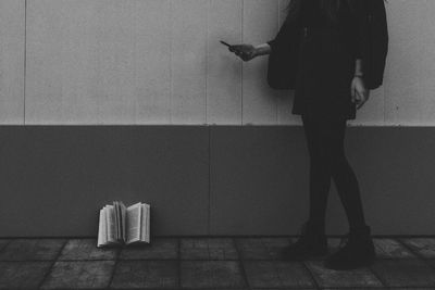 Low section of woman standing on tiled floor