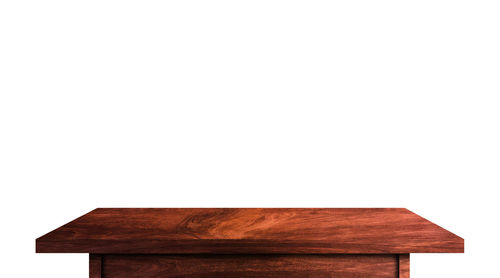 Close-up of wooden table against white background