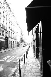 Empty road with buildings in background