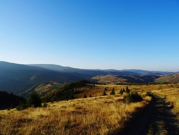 Scenic view of mountains against clear blue sky