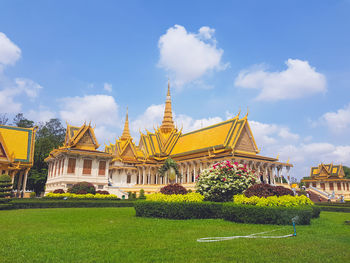 Temple by building against sky